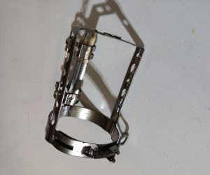 Bottle cage for racing bicycle from 1960 with spring and clamps on the frame